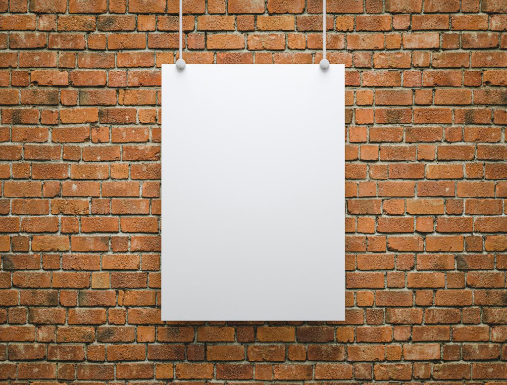 blank poster hanging on a wall