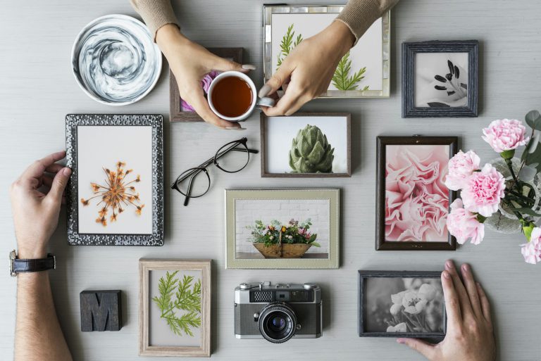 Hand with Photo Frame on Gray Background